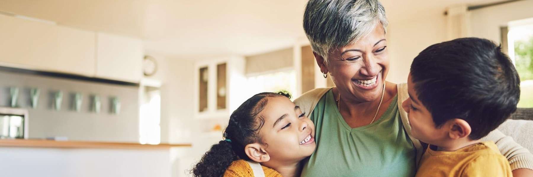 A woman Smiling Together with her kids after getting dental implants in Birmingham, AL