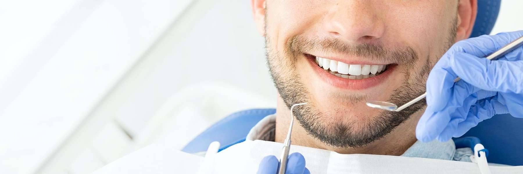 Photo of man looking at teeth cleaning tools in Birmingham, AL