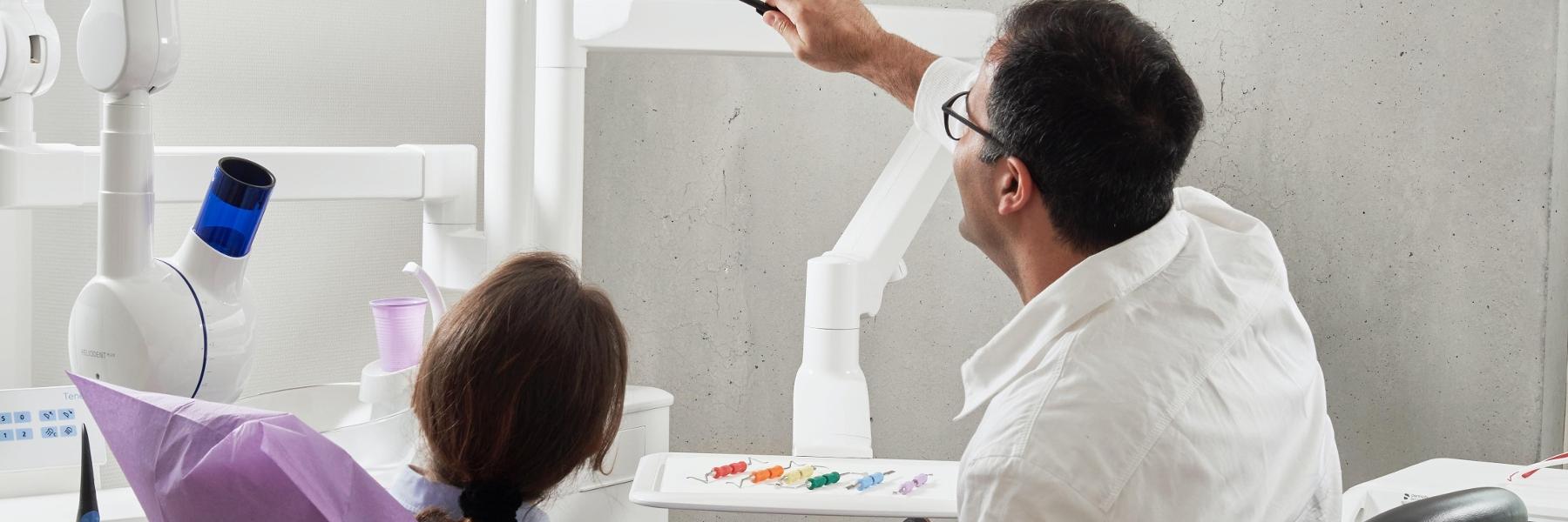Dentist talking to patient in Birmingham, AL