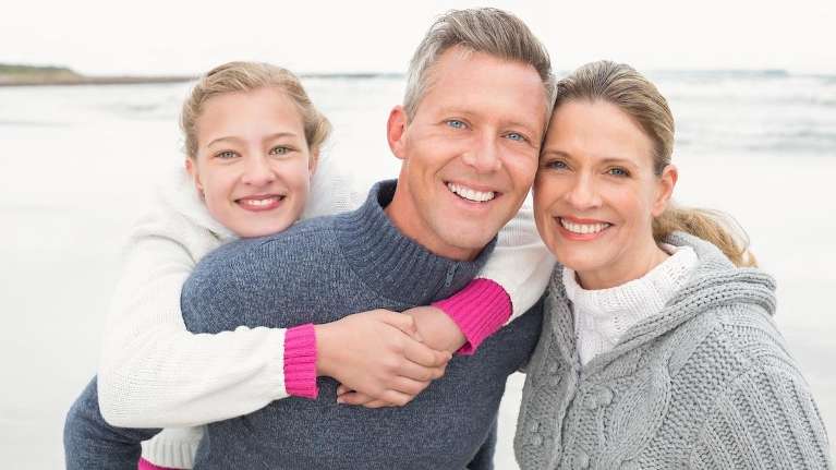 A Family Smiling Together after getting dental implants in Birmingham, AL