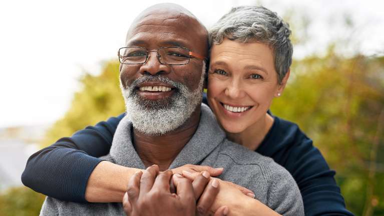 Interracial couple hugging after a Dental Implant in Birmingham, AL