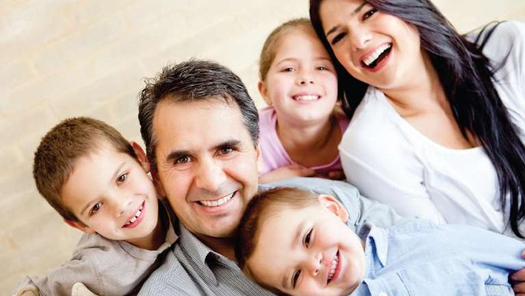 Family smiling after dental check up in Birmingham, AL