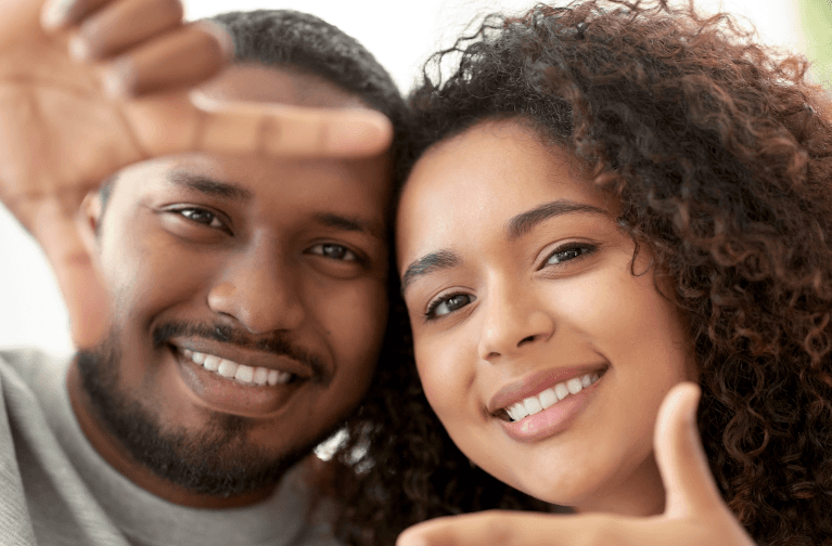 A young couple posing for a photo after Dental Implant traetment in Birmingham, AL