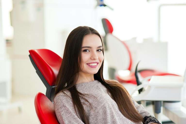 A woman smiling after getting veneers in Birmingham, Al 