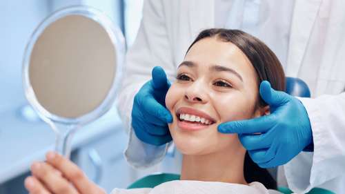 A woman smiling after a Natural-Looking Porcelain Veneers treatment in Birmingham, AL