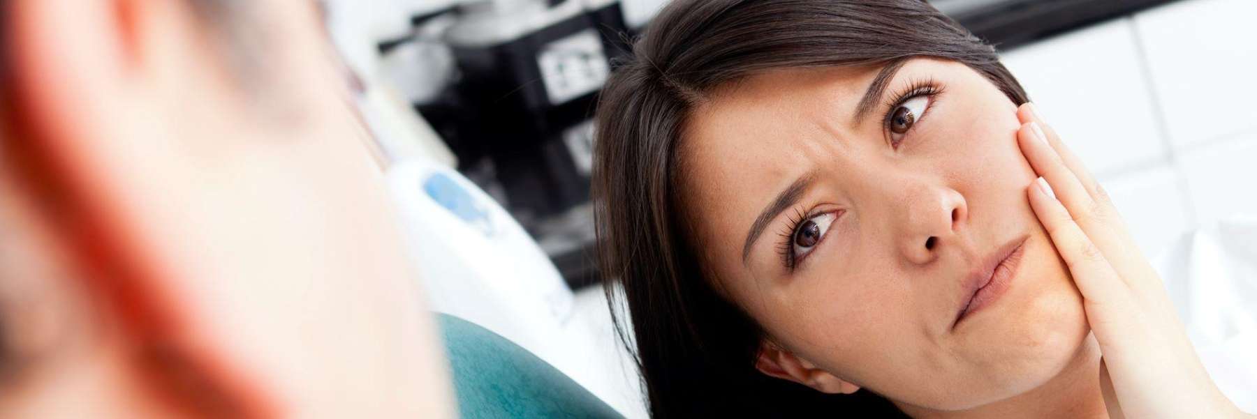 Lady holding his jaw due to migraines in Birmingham, AL
