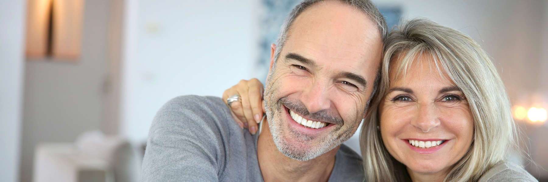 An elderly couple smiling after getting Dentures in Birmingham, AL